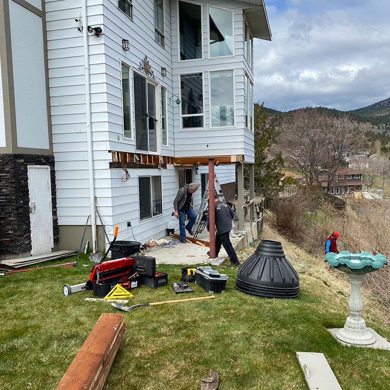 Deck Medic Penticton Deck Medic Penticton working on concrete deck for grey house